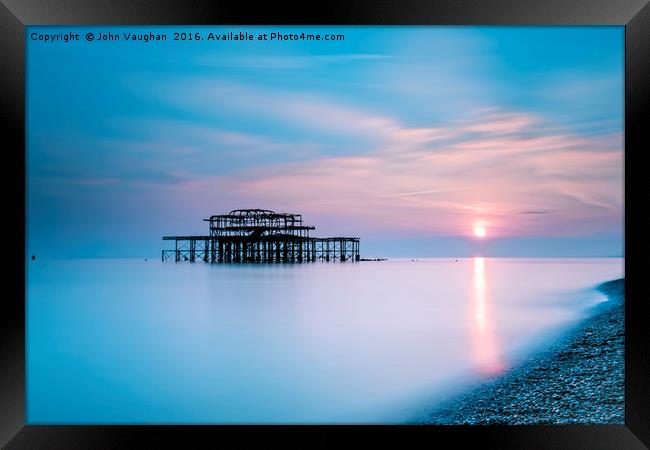 Sunset at Brighton West Pier Framed Print by John Vaughan