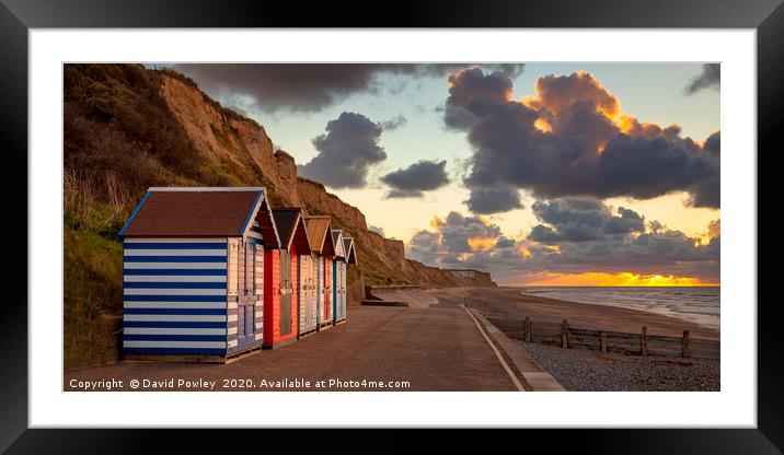 Cromer beach huts at sunset Framed Mounted Print by David Powley