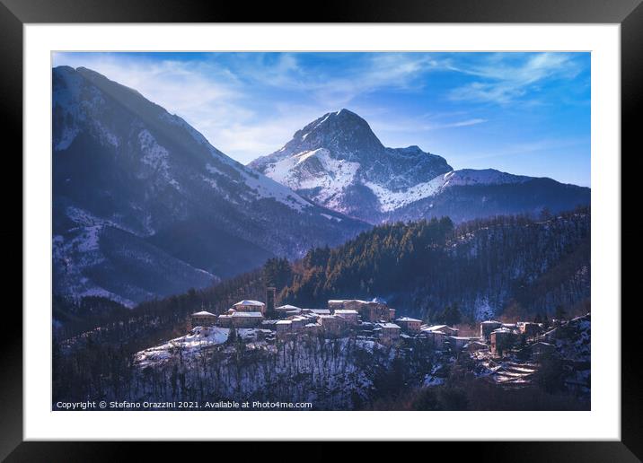 Snowy village and Apuan mountains in winter. Framed Mounted Print by Stefano Orazzini