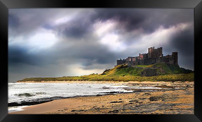 Stormy sky over Bamburgh Castle Framed Print by Kevin Tate